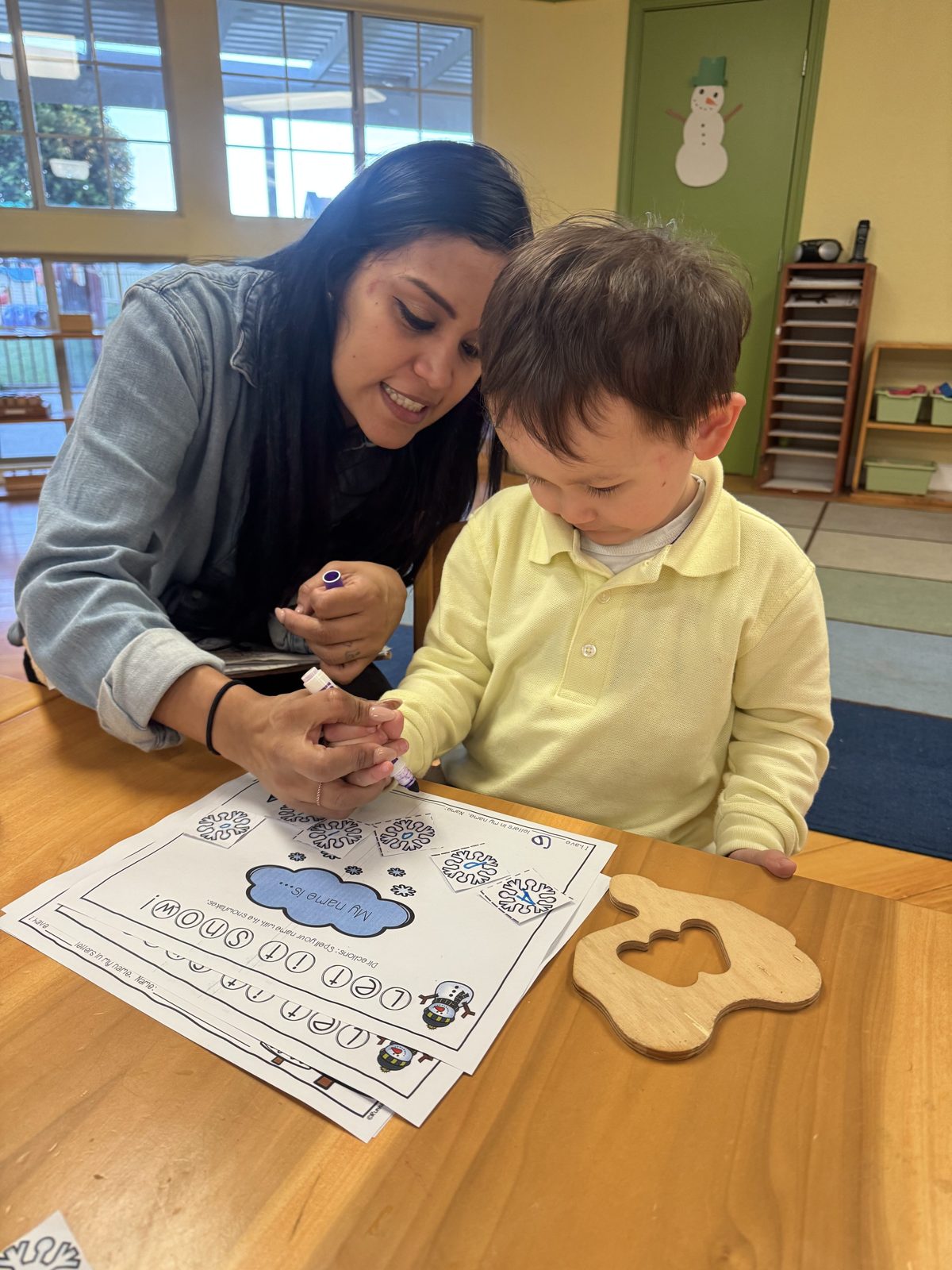 Teacher guiding a child with Montessori materials